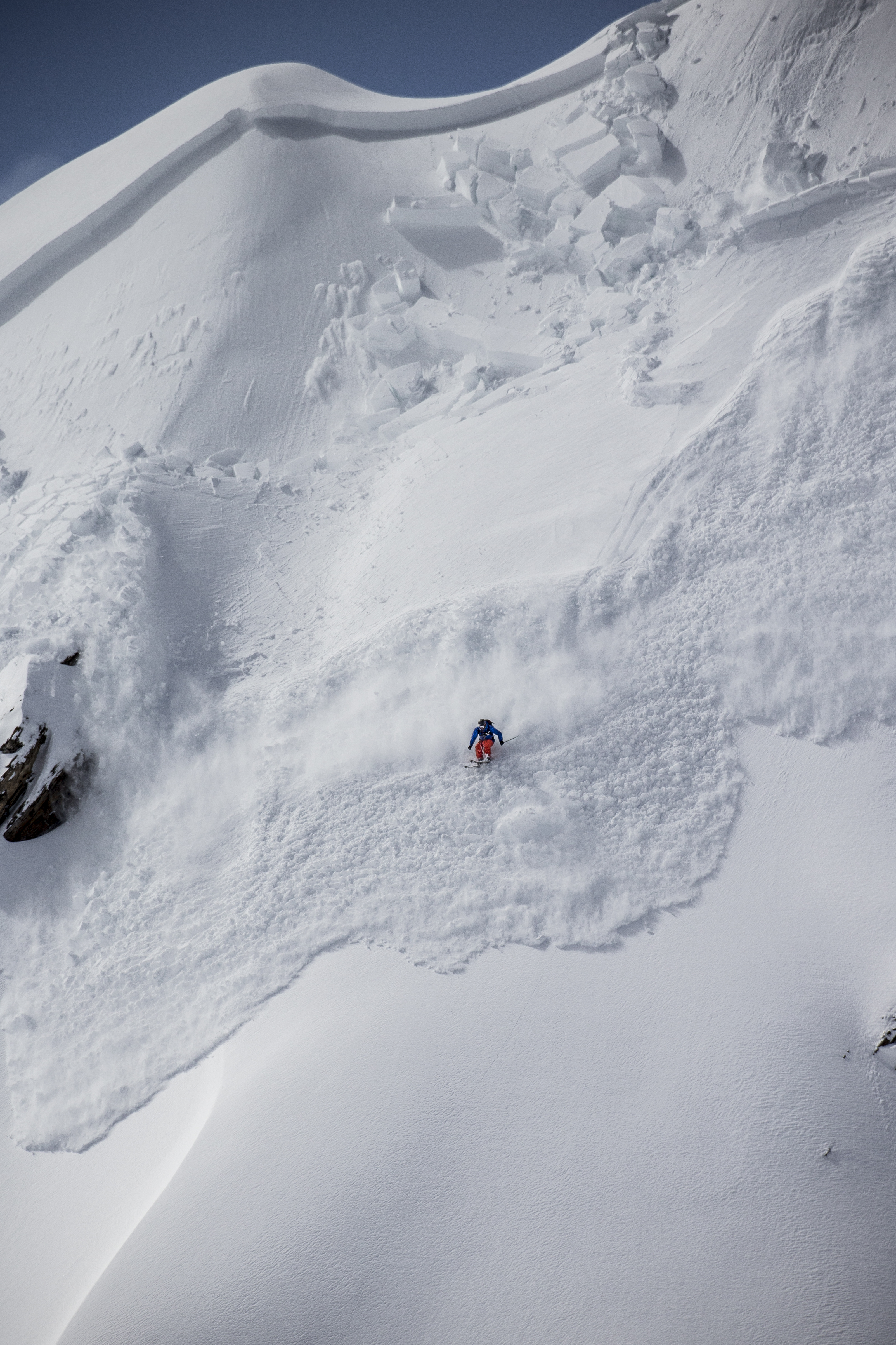 Skier below an avalanche slope