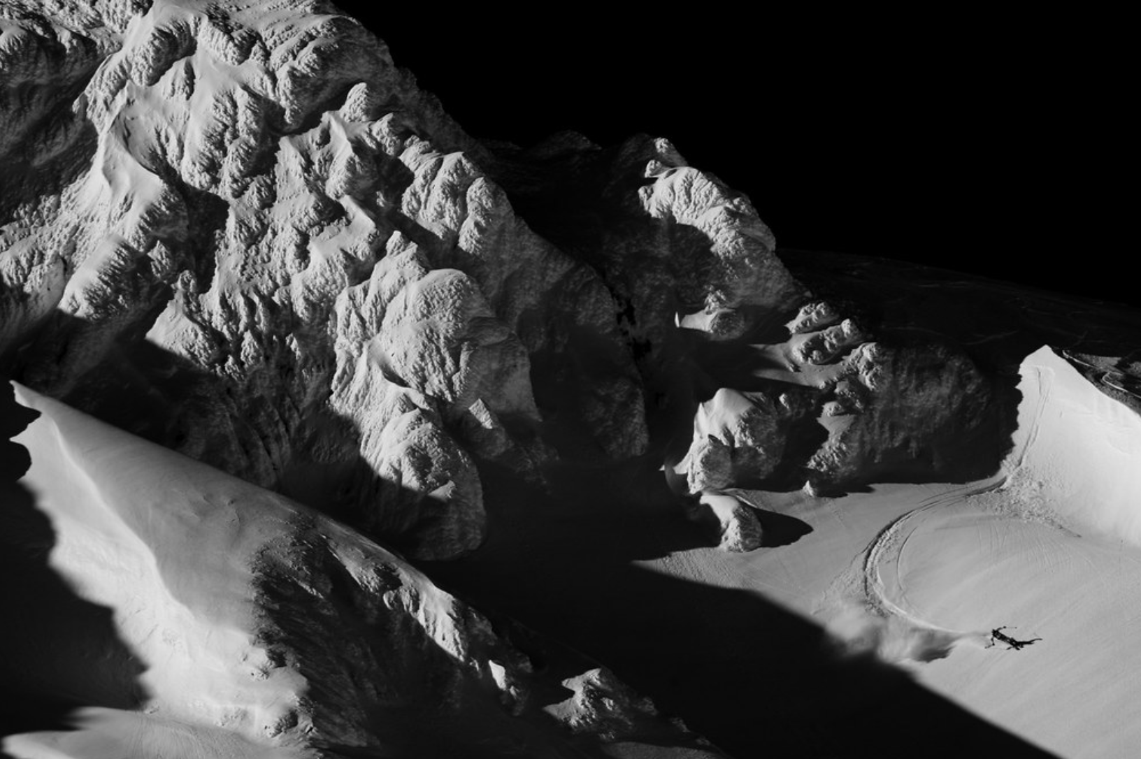 Dominique Perret carving through deep powder