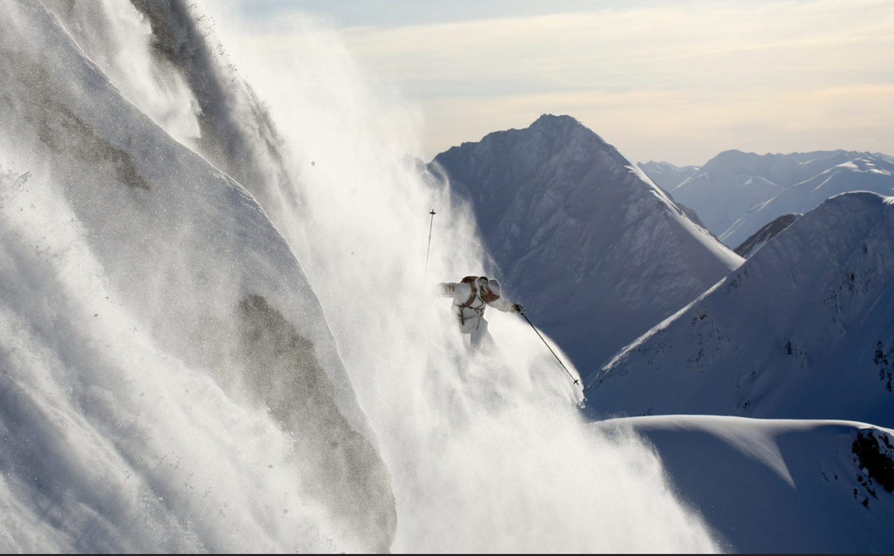 Skier dropping a spine wall in Alaska